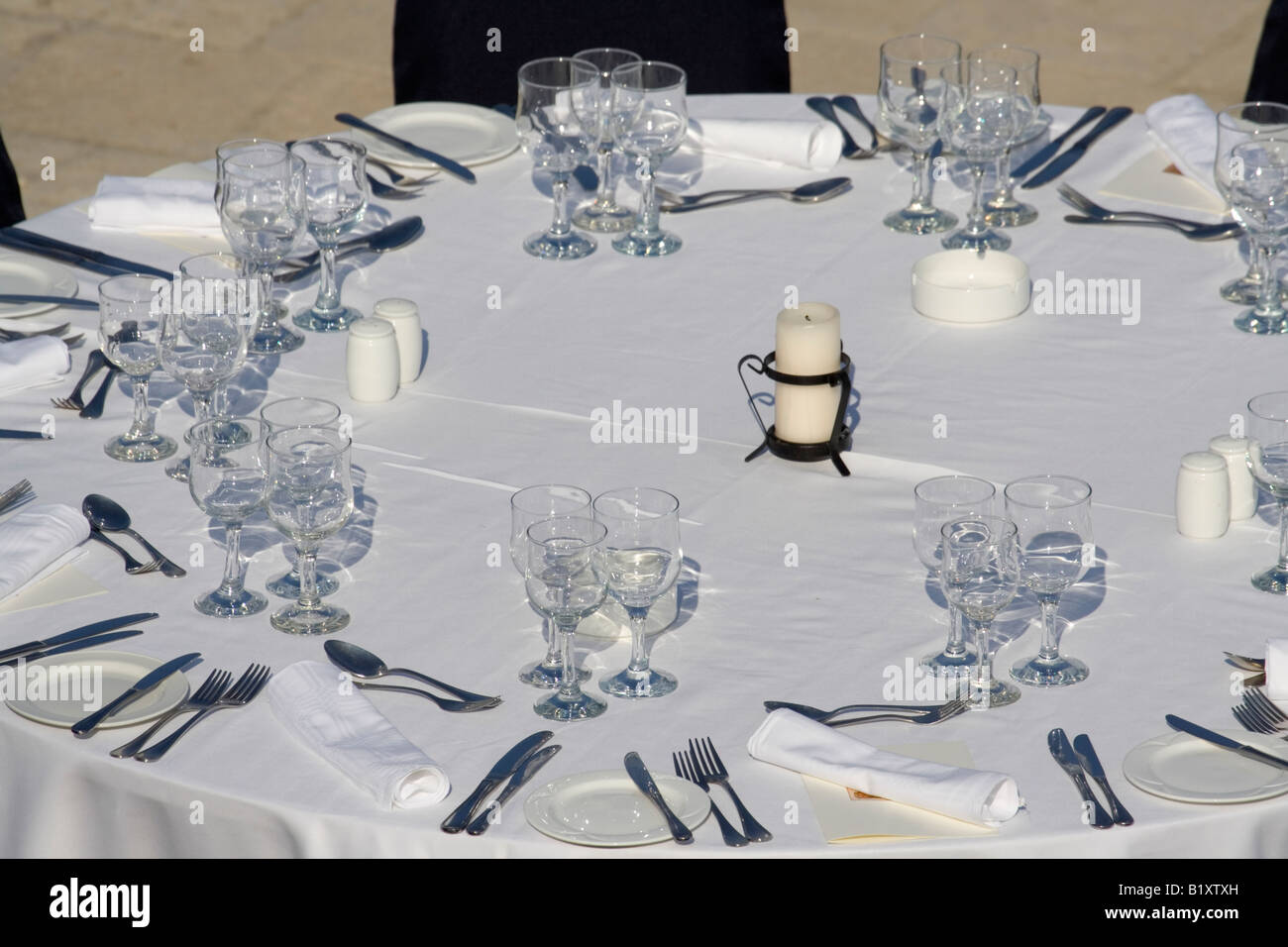 Dinner table arrangement set for guests Stock Photo