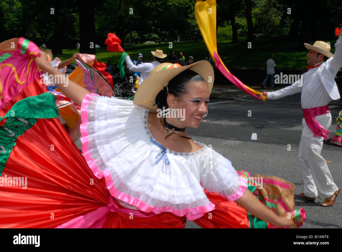 Colombian folk dancers perform in a flower parade on Central Park West