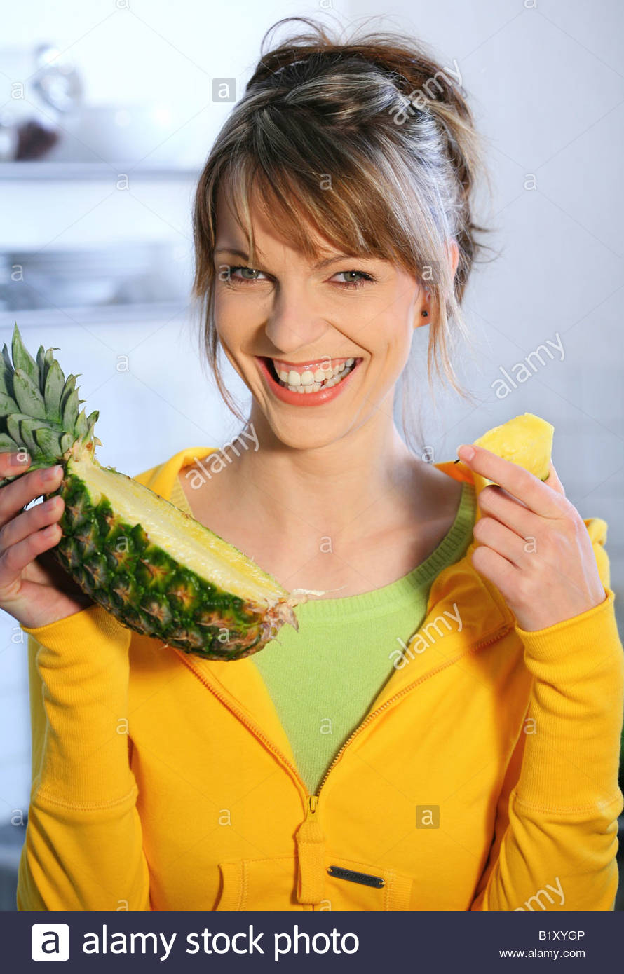 woman eating pineapple Stock Photo