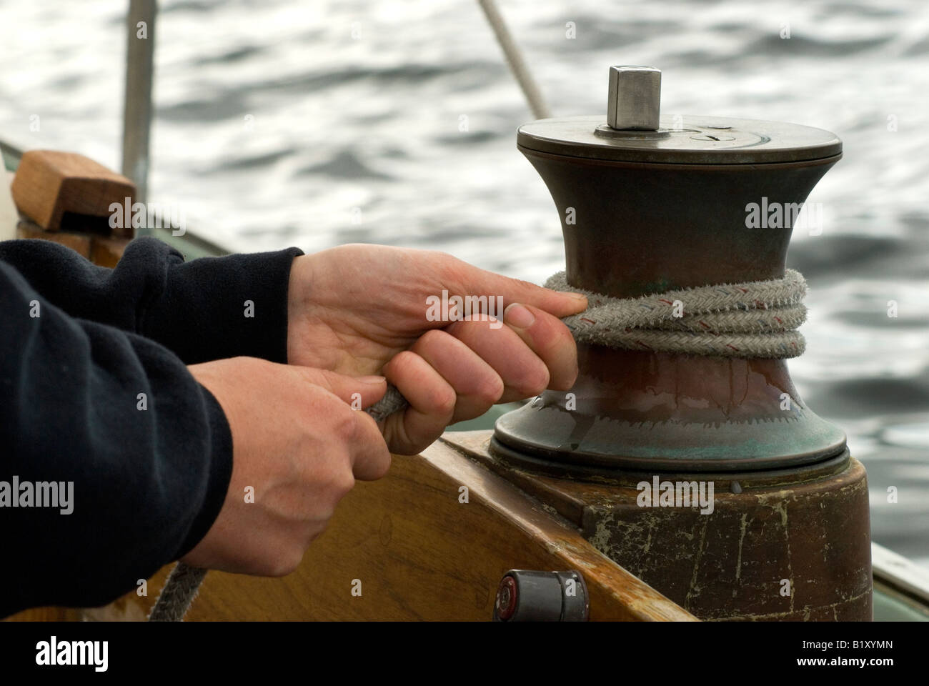 Hands and a winch with a rope Stock Photo Alamy