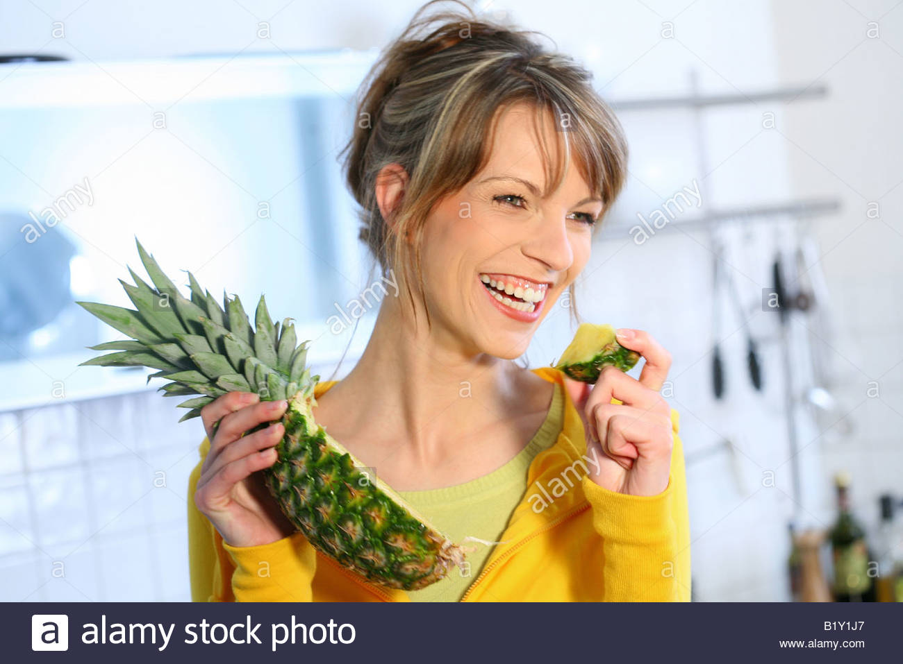 woman eating pineapple Stock Photo