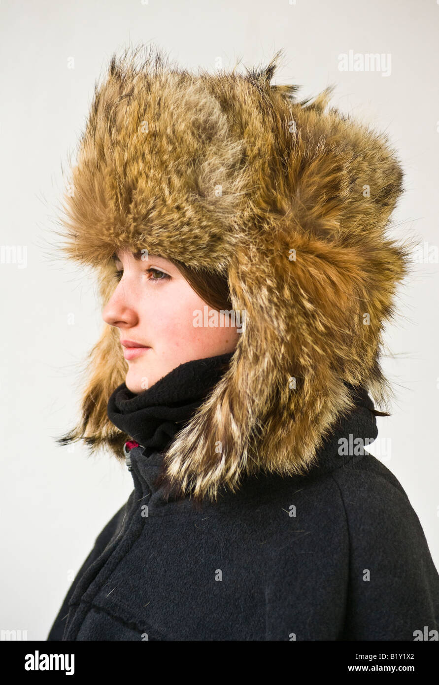 Young British  girl wearing a genuine Afghan fur hat with drop down ear flaps Stock Photo