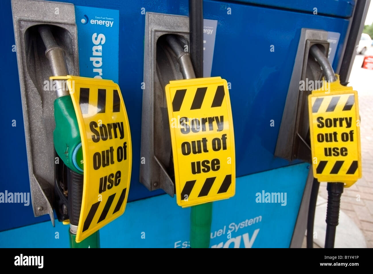 Out of use petrol pumps warning displayed at an Esso petrol station without fuel. Stock Photo