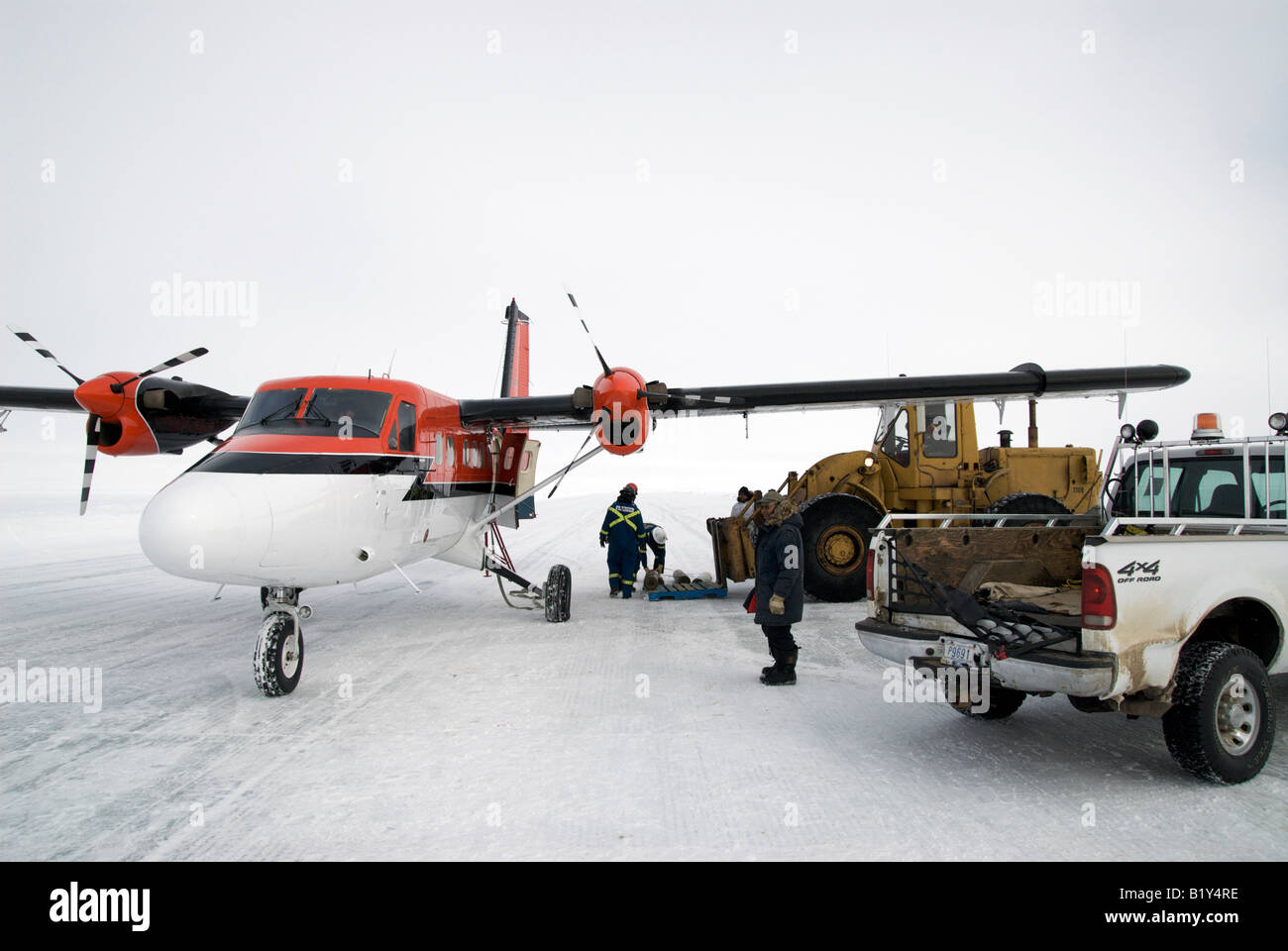 Twin Otter DHC-6, northern workhorse, on a runway made of ice on the Beaufort Sea, Canadian Arctic. Taking a load from the rig. Stock Photo