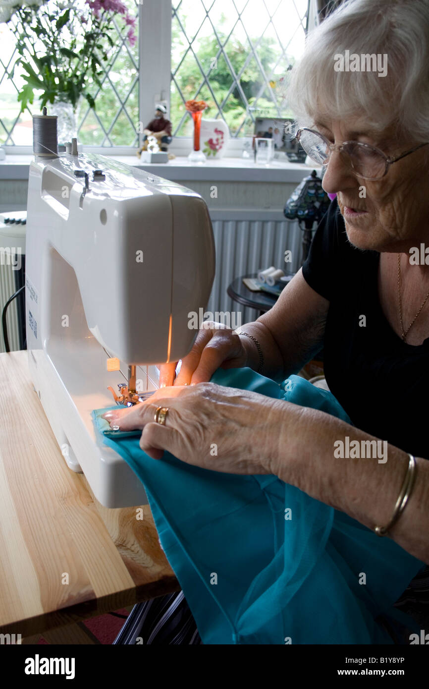 Elderly lady using sewing machine Stock Photo Alamy