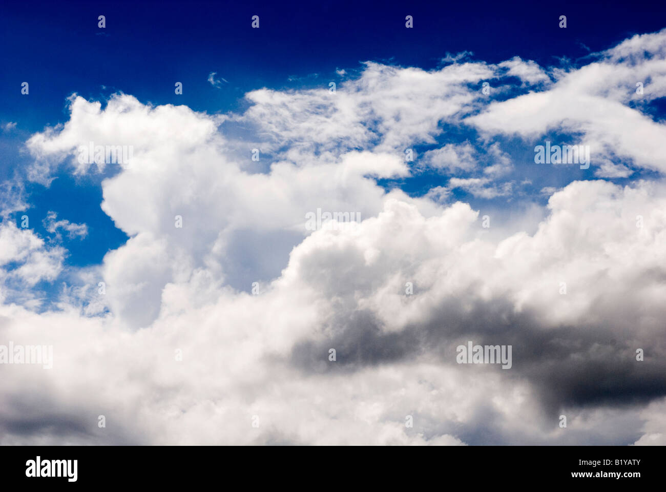 Fluffy white clouds in a blue sky Stock Photo - Alamy