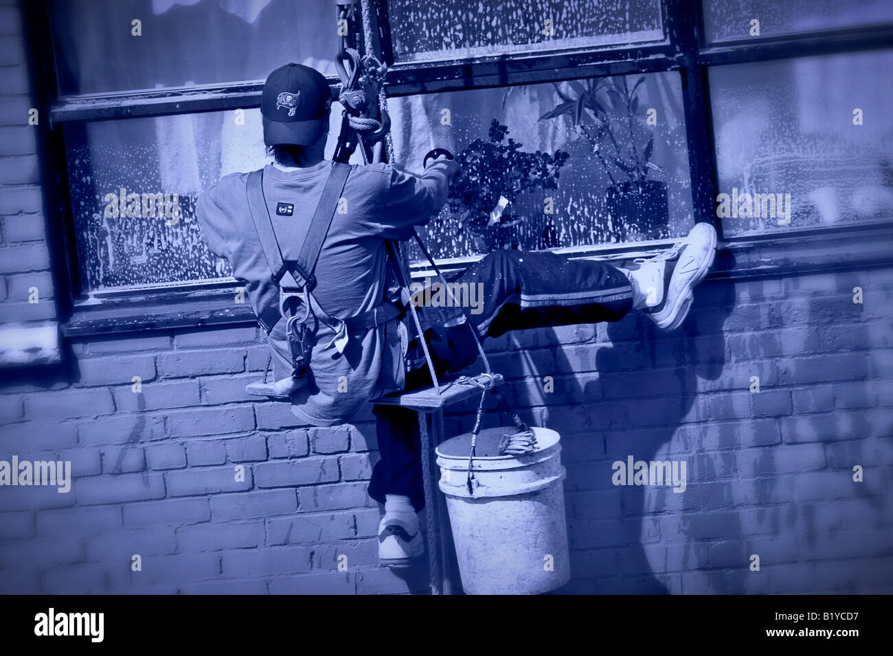 hangin from a ropes washing windows Stock Photo Alamy