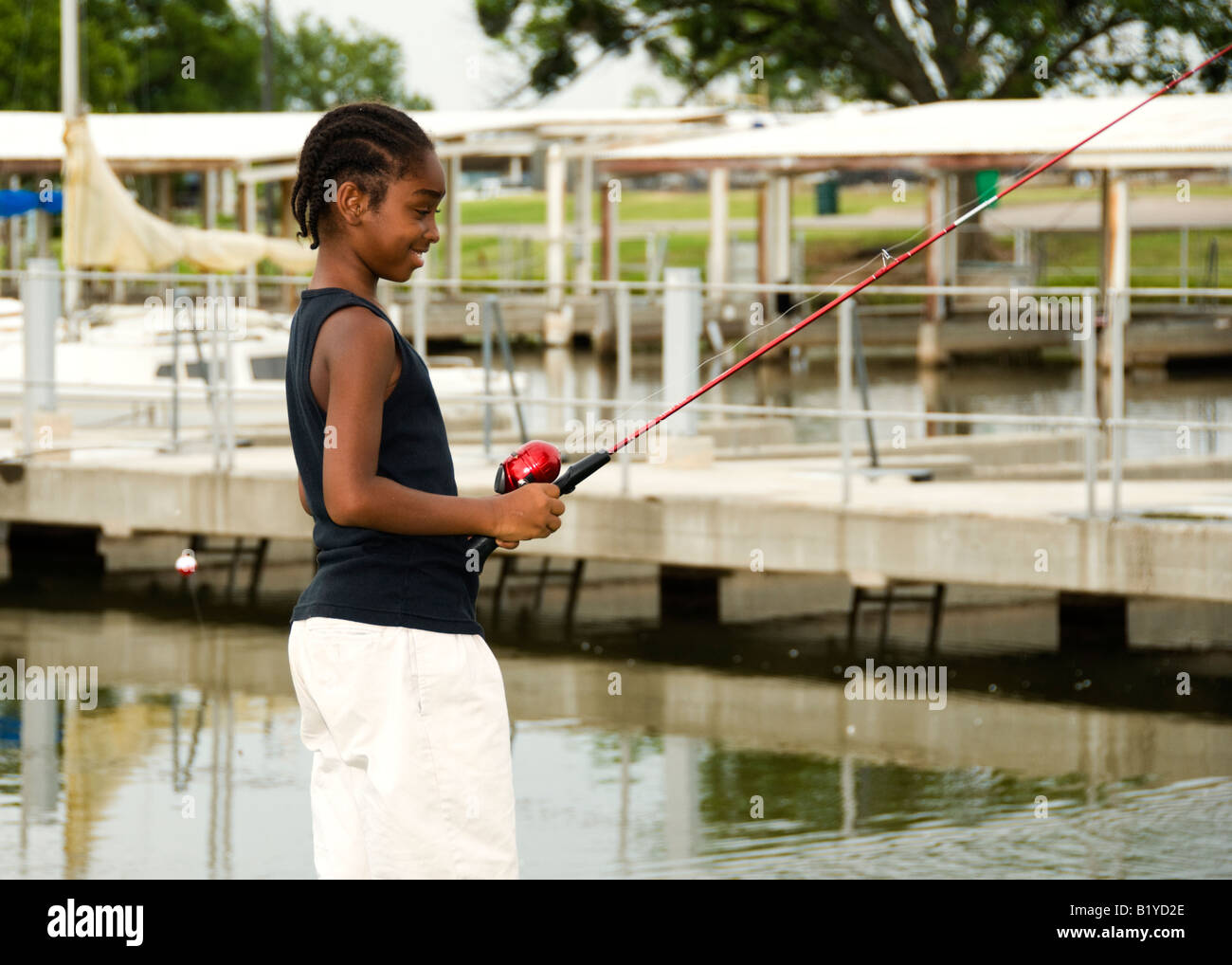 African american boy fishing in hi-res stock photography and