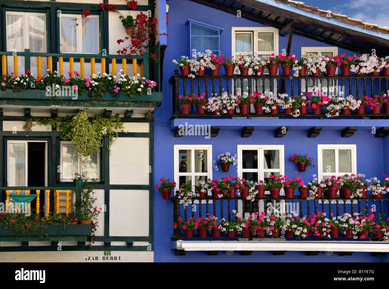 Colourful flower-bedecked balconies of houses in Hondarribia, Spain Stock Photo
