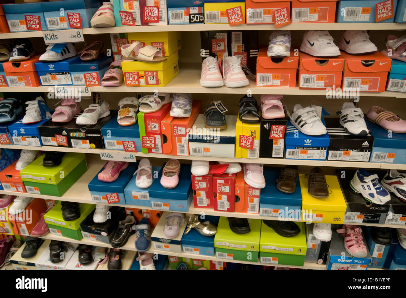 rows and shelves of cheap Childrens shoes sale half price in Brantano Shoe  store UK Stock Photo - Alamy