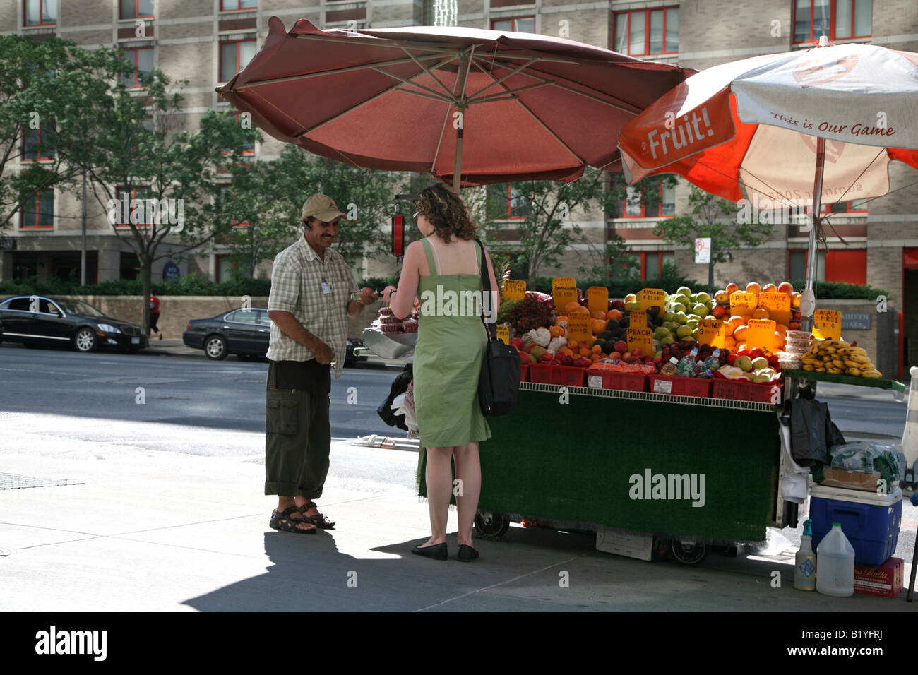 Woman buying fruit at a fruit stand, New York, NY, USA Stock Photo