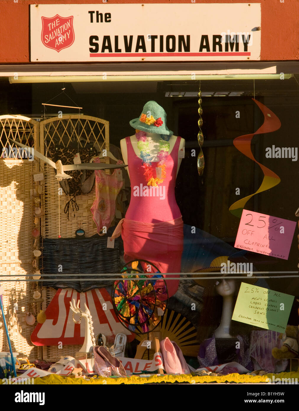 Salvation Army charity shop window display full of summer clothes Stock