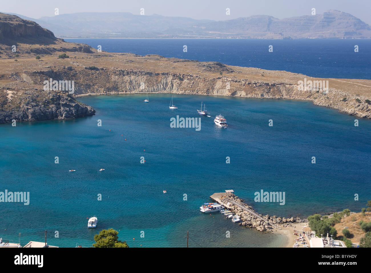 Looking down on the Little Harbour of the Apostle Paul from Lindos Acropolis on the Greek Island of Rhodes. Stock Photo