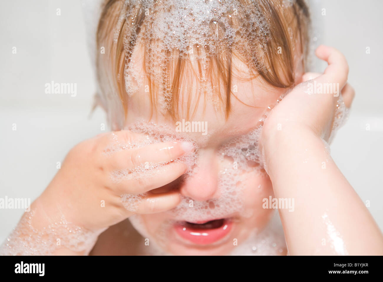 Baby child with soap in her eyes Stock Photo Alamy
