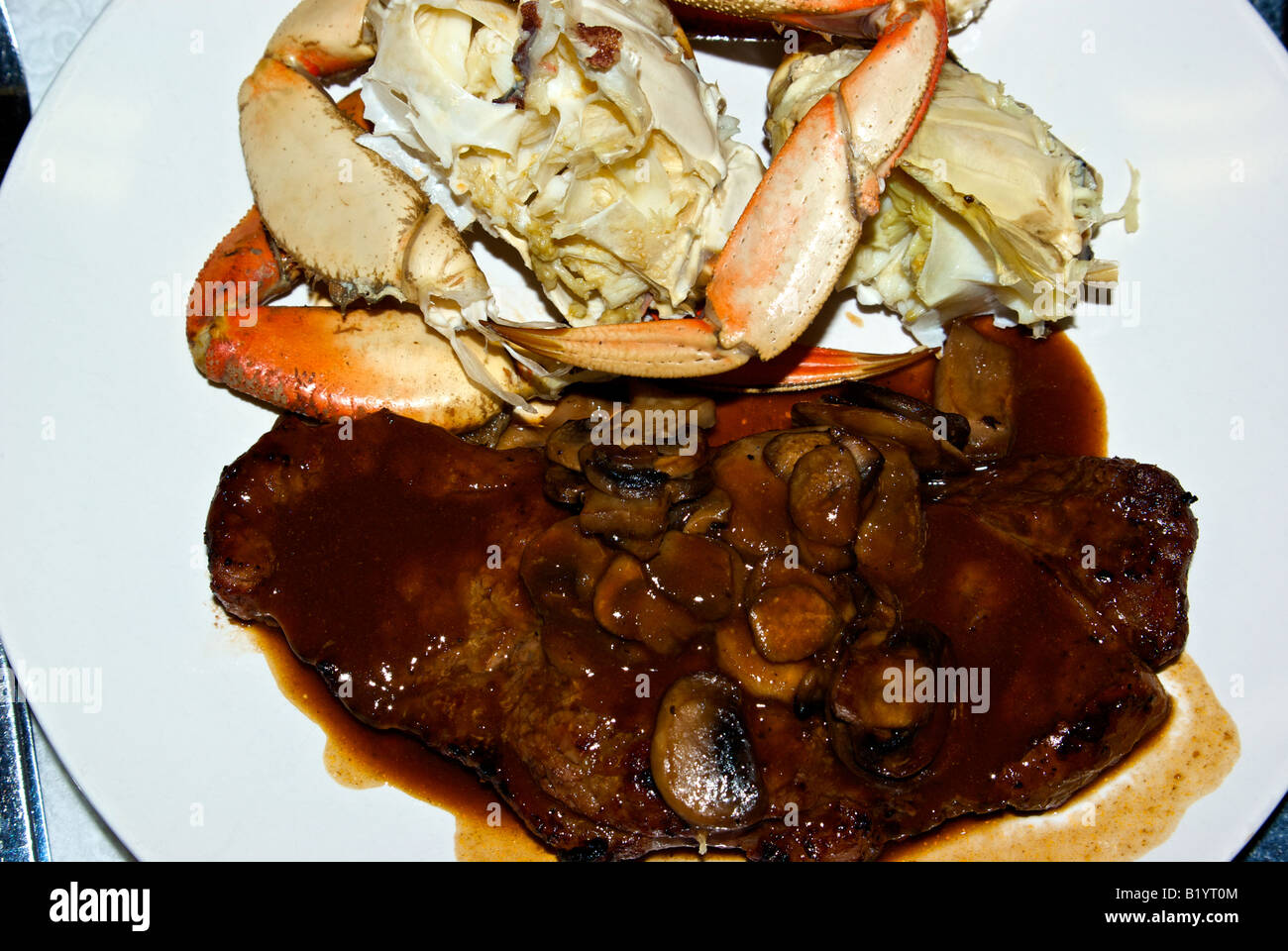 Grilled New York cut steak with a mushroom demi glace and fresh cooked ...