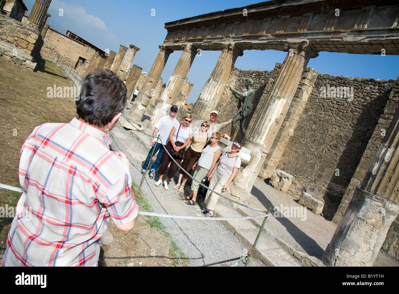 Tourists having photo taken Temple of Apollo Pompeii Campania Italy Stock Photo