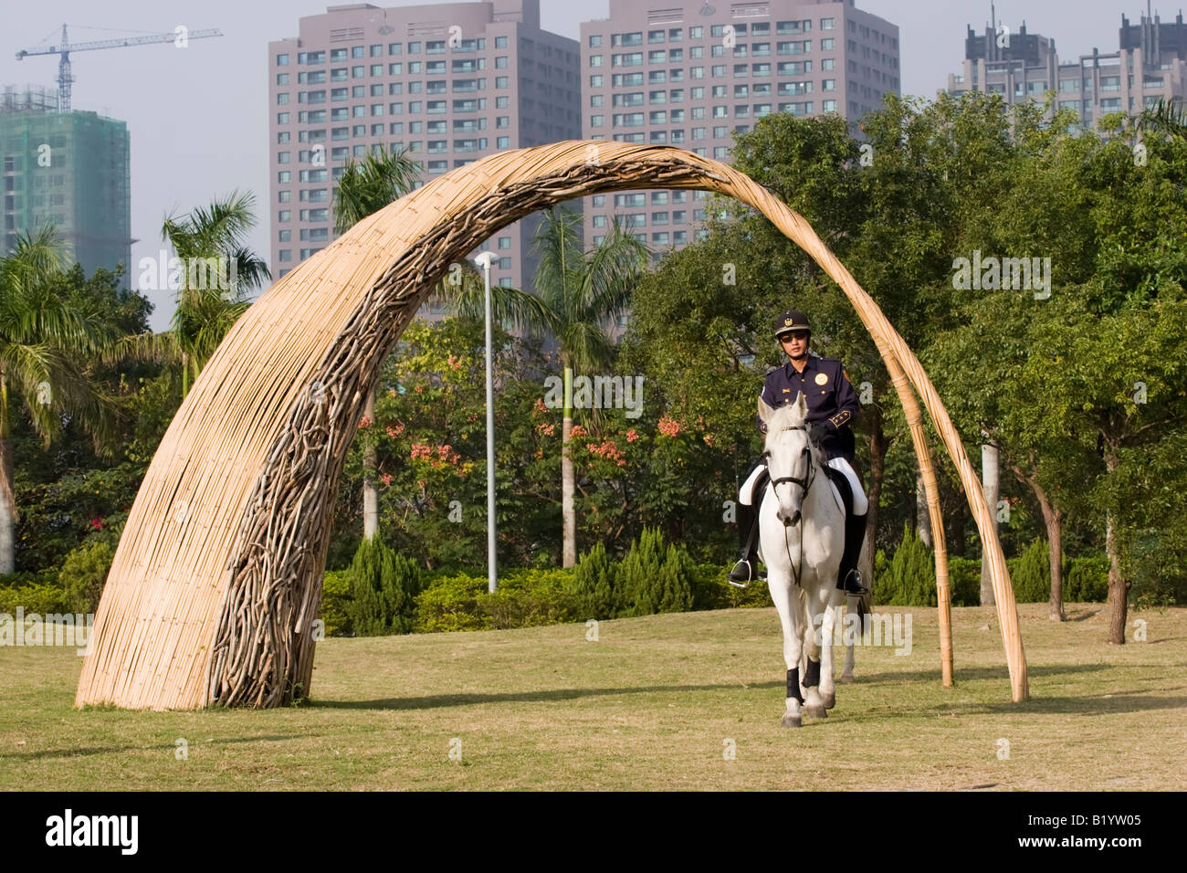 Taiwanese mounted policeman and horse walk under a cane archway, Kaohsiung Museum of Fine Arts, Kaohsiung Taiwan ROC Stock Photo