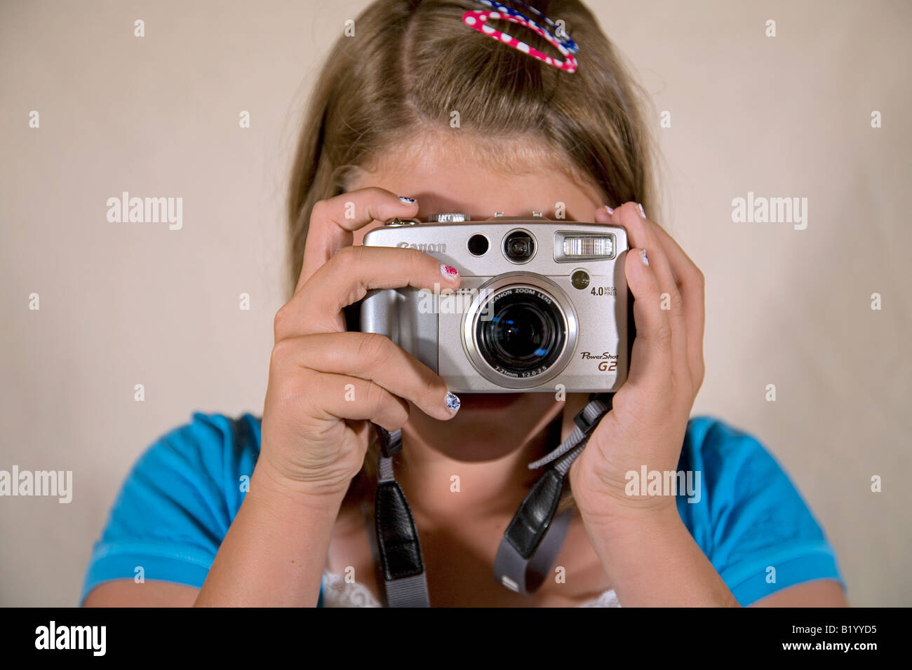 A teen aged girl taking a picture with a digital camera Stock Photo