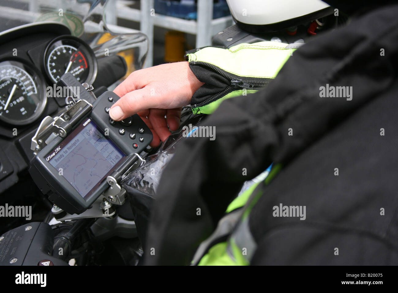 motorcyclist operating satellite navigation system Stock Photo - Alamy