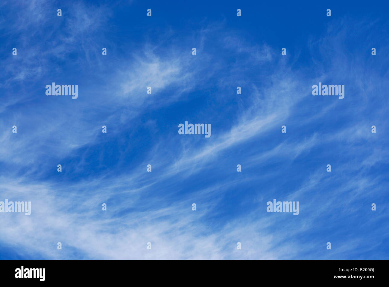 White wispy clouds against a deep blue sky Stock Photo - Alamy