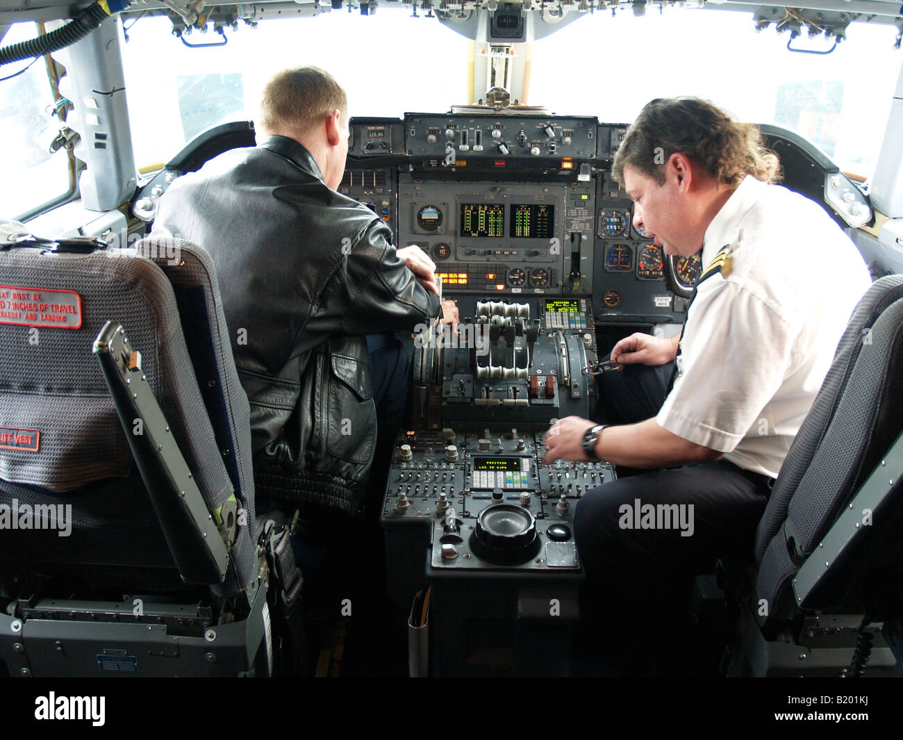 Pilot and copilot performing preflight check in cockpit of 747 Freighter Aircraft Stock Photo