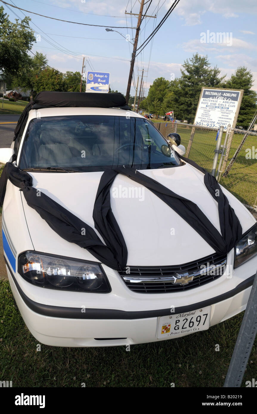 Police car draped in black to honor a policeman killed in action