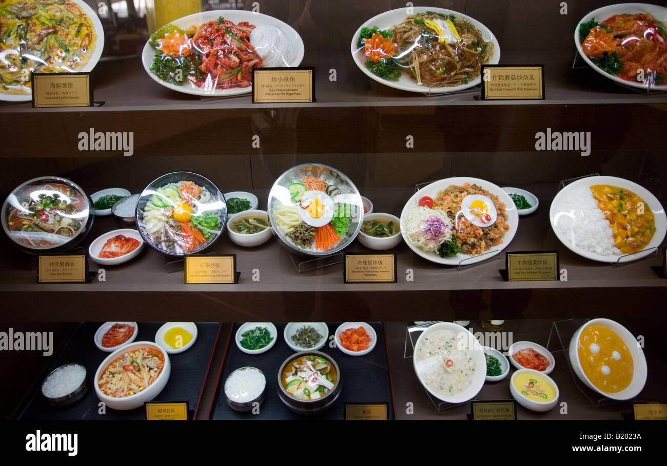 Plates of food on display in a Terminal Three restaurant of Beijing Capital International Airport China Stock Photo