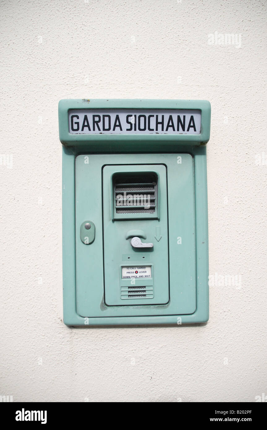 Garda Siochana call box on the wall of a part-time Police Station, known as a 'Green Man' Stock Photo