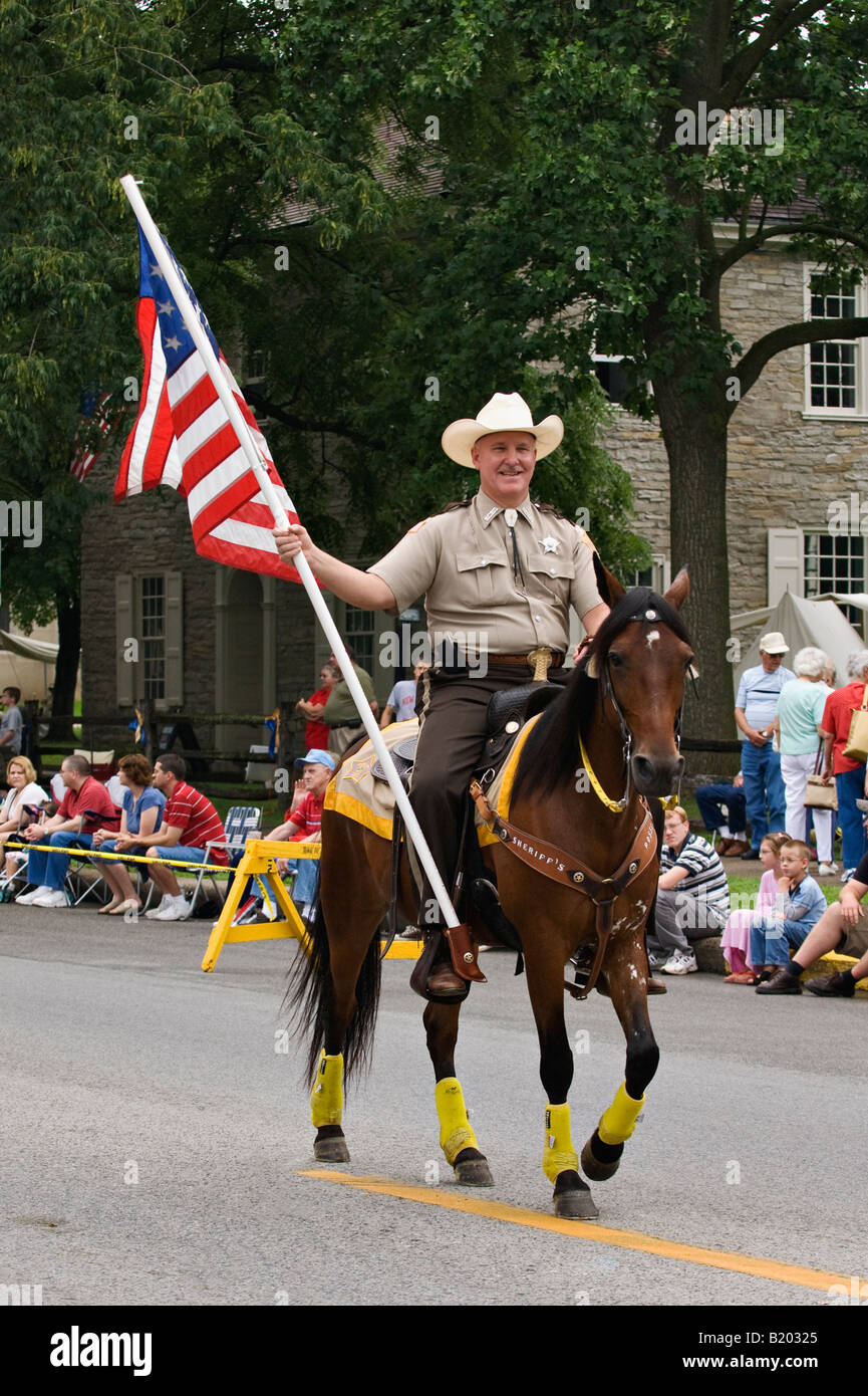 County Sheriff on Horseback Carrying American Flag in Indepedence Day Parade Corydon Indiana Stock Photo