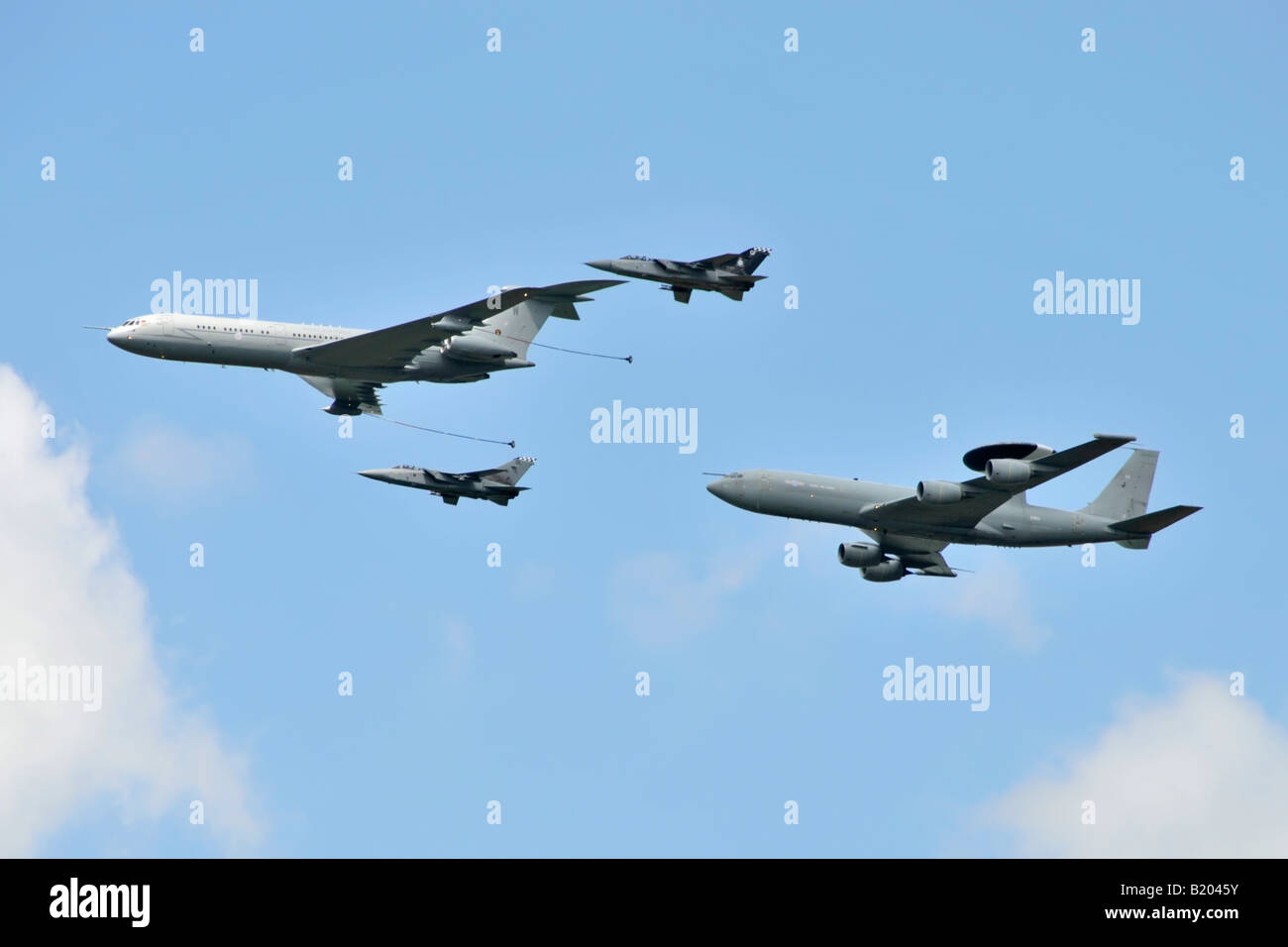 Formation of RAF Vickers VC10 in flight refuel tanker aircraft followed by Boeing E3 AWACS plane escorted by 2 Tornado FR3 jets Stock Photo