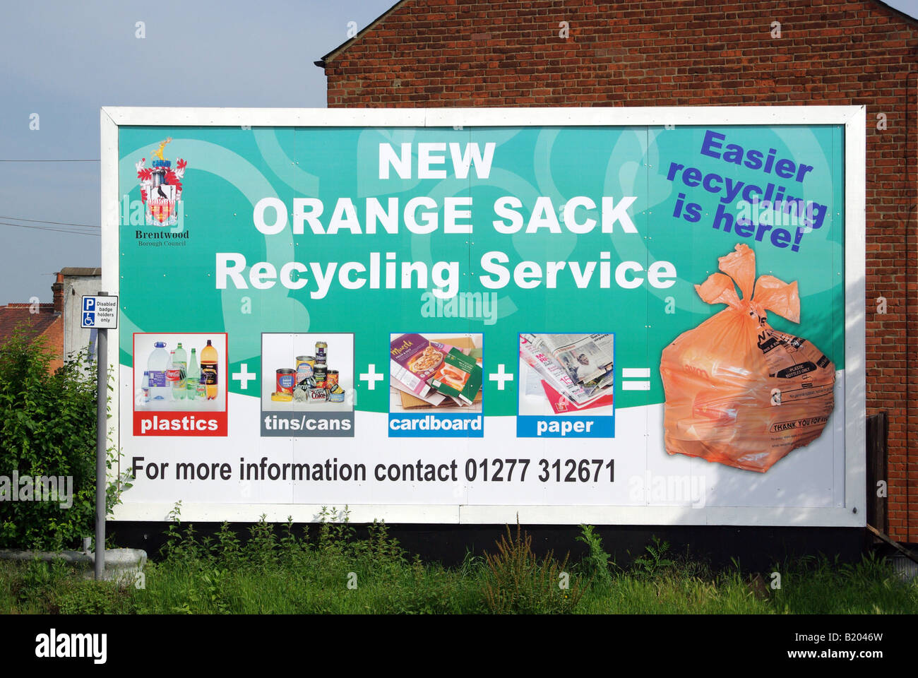 Brentwood Borough Council advertising billboard in the town center to promote household rubbish recycling in orange sacks Stock Photo