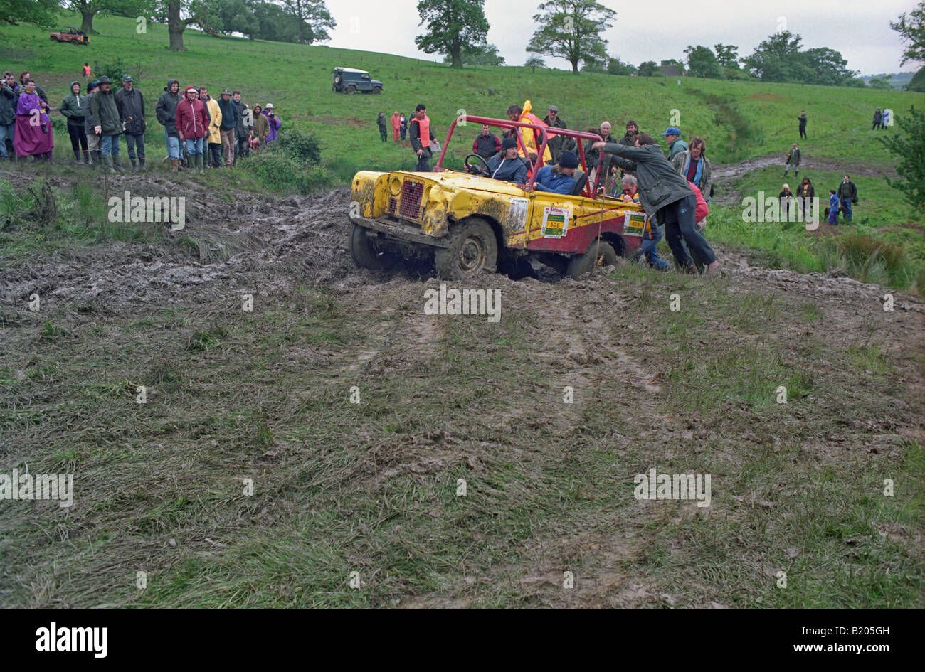 Spectators at the 1993 A.R.C. National Rally pushing a stuck Land Rover ...