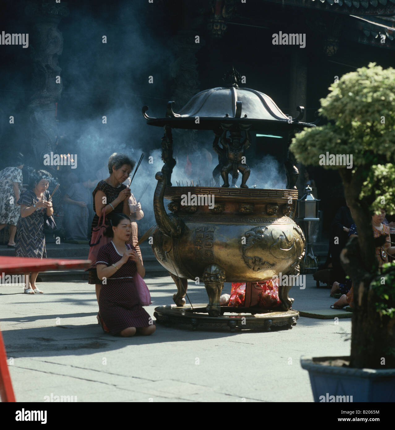 Taipei.Lungshan (Dragon Mountain)Temple isTaipei's oldest.It is near old city center.Elder women pray, they have done since 1738 Stock Photo