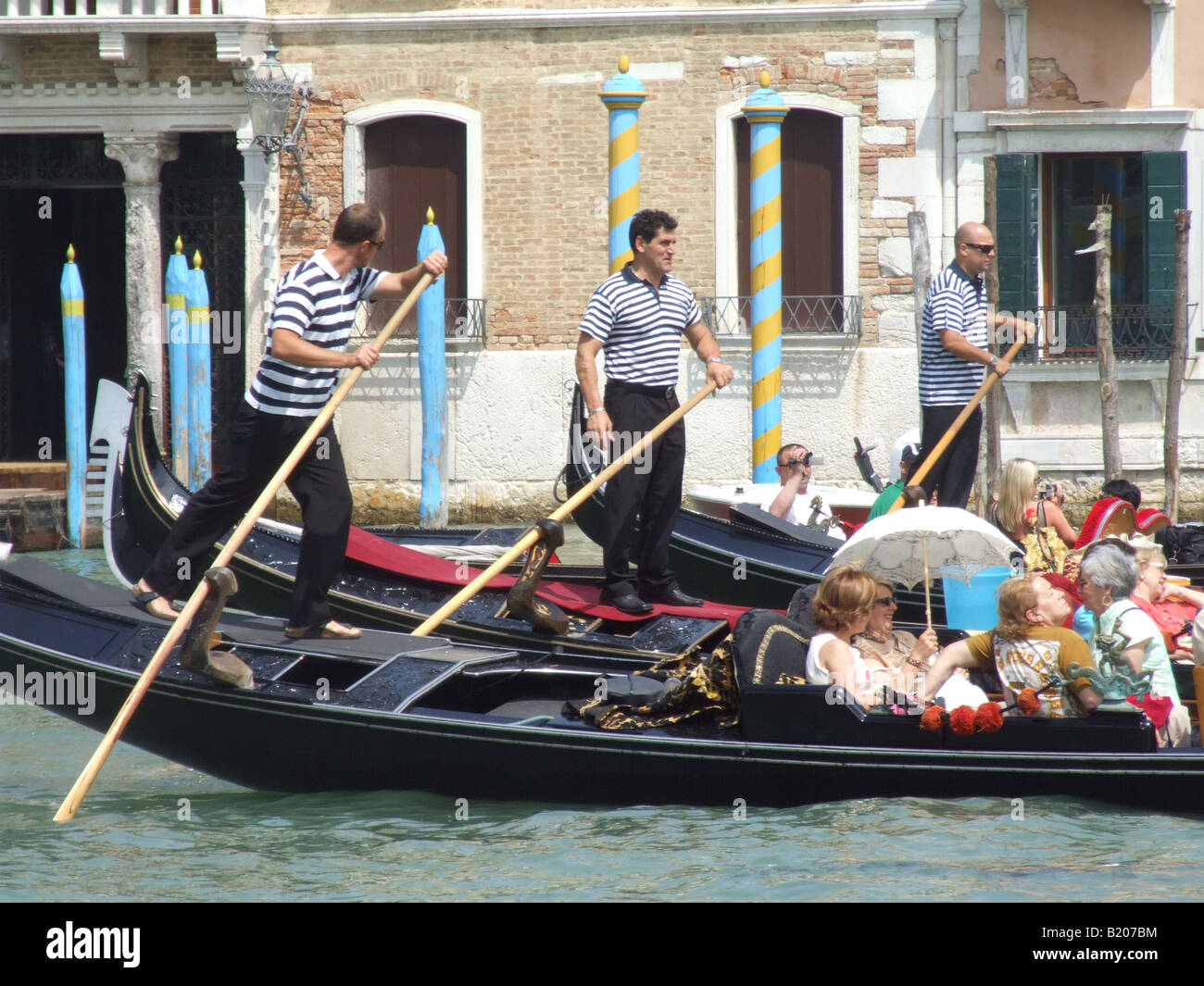 group of tourists on gondola in venice italy Stock Photo