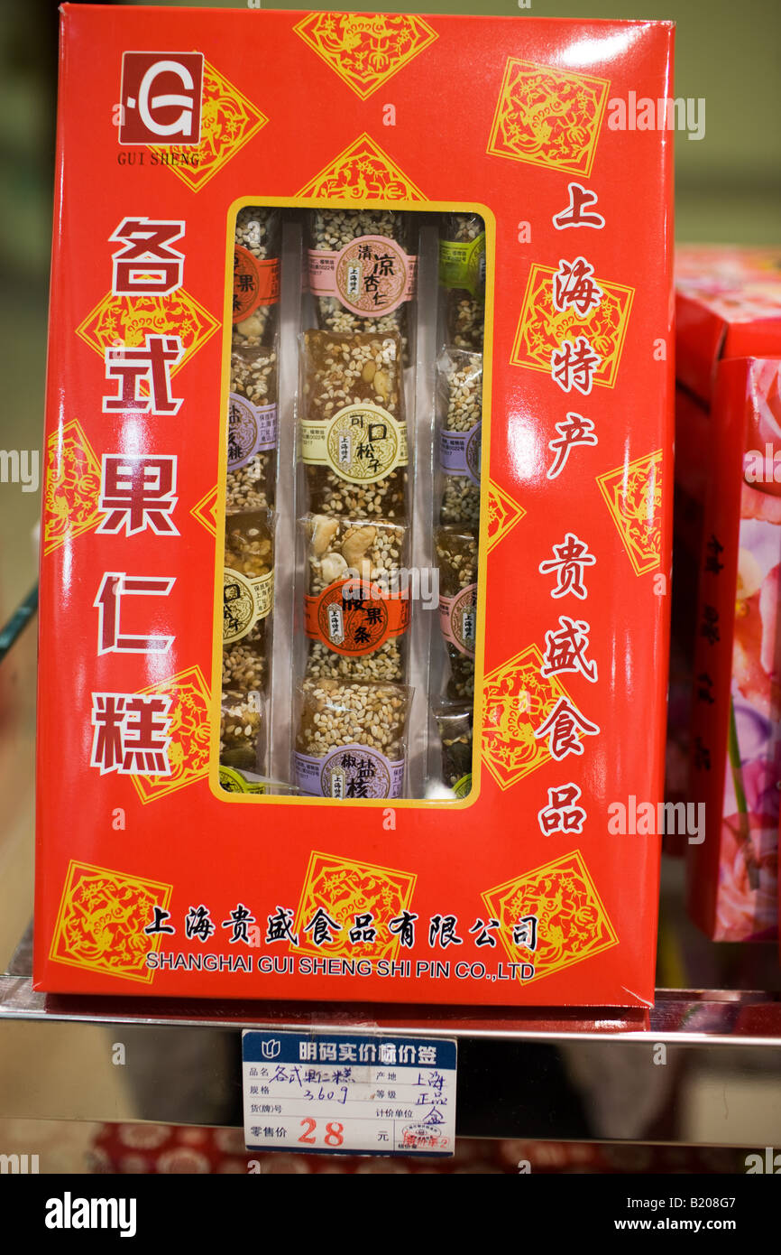 Box of Chinese sweets with nuts and sesame seeds on sale in souvenir shop Shanghai China Stock Photo