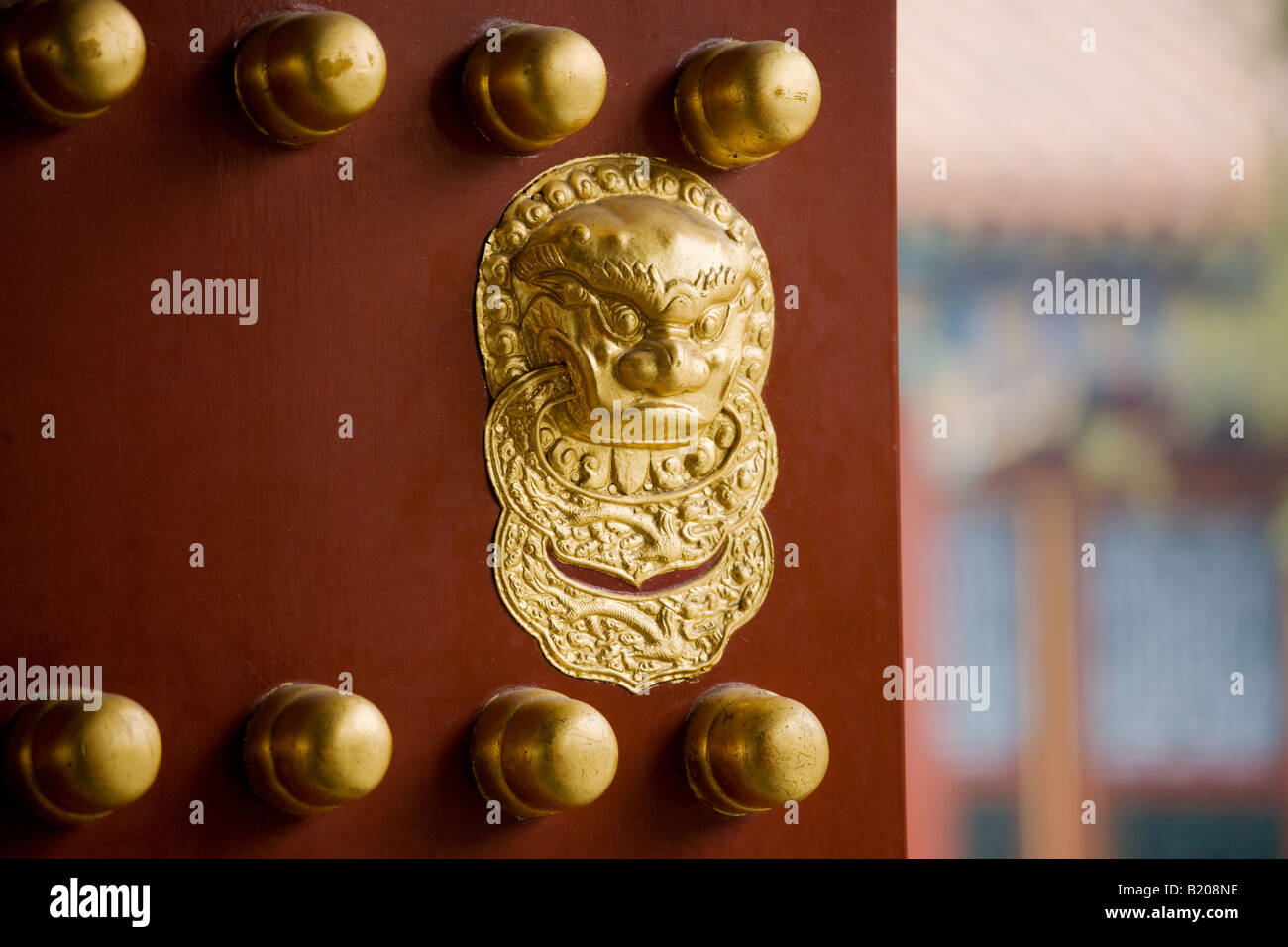Nails and lion head knocker on gate to Tower of Buddhist Incense at The Summer Palace Beijing China Stock Photo
