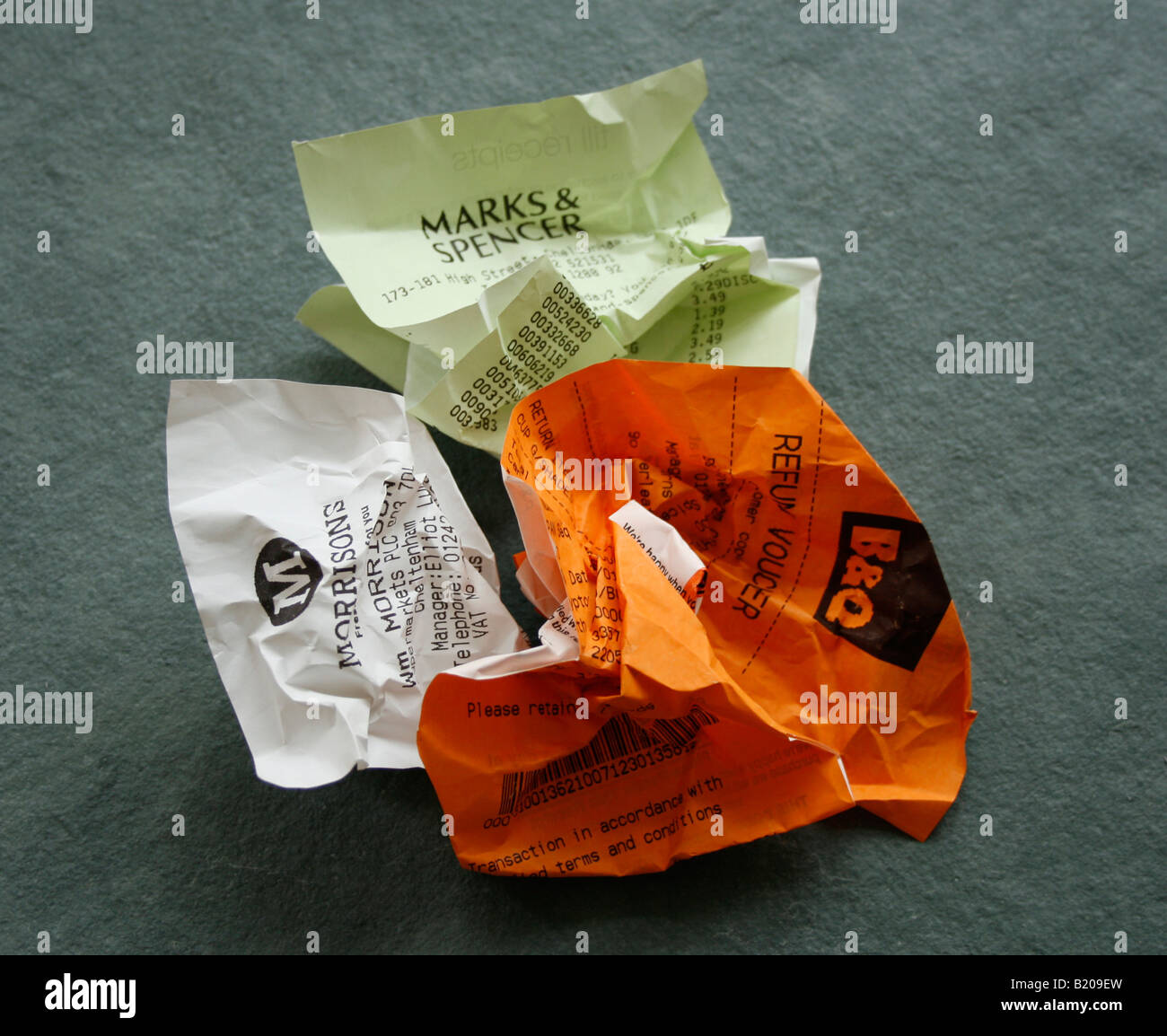 Coloured and crumpled shop receipts. ( B&Q (orange), Marks & Spencer (green) and Morrisons ( white). Stock Photo