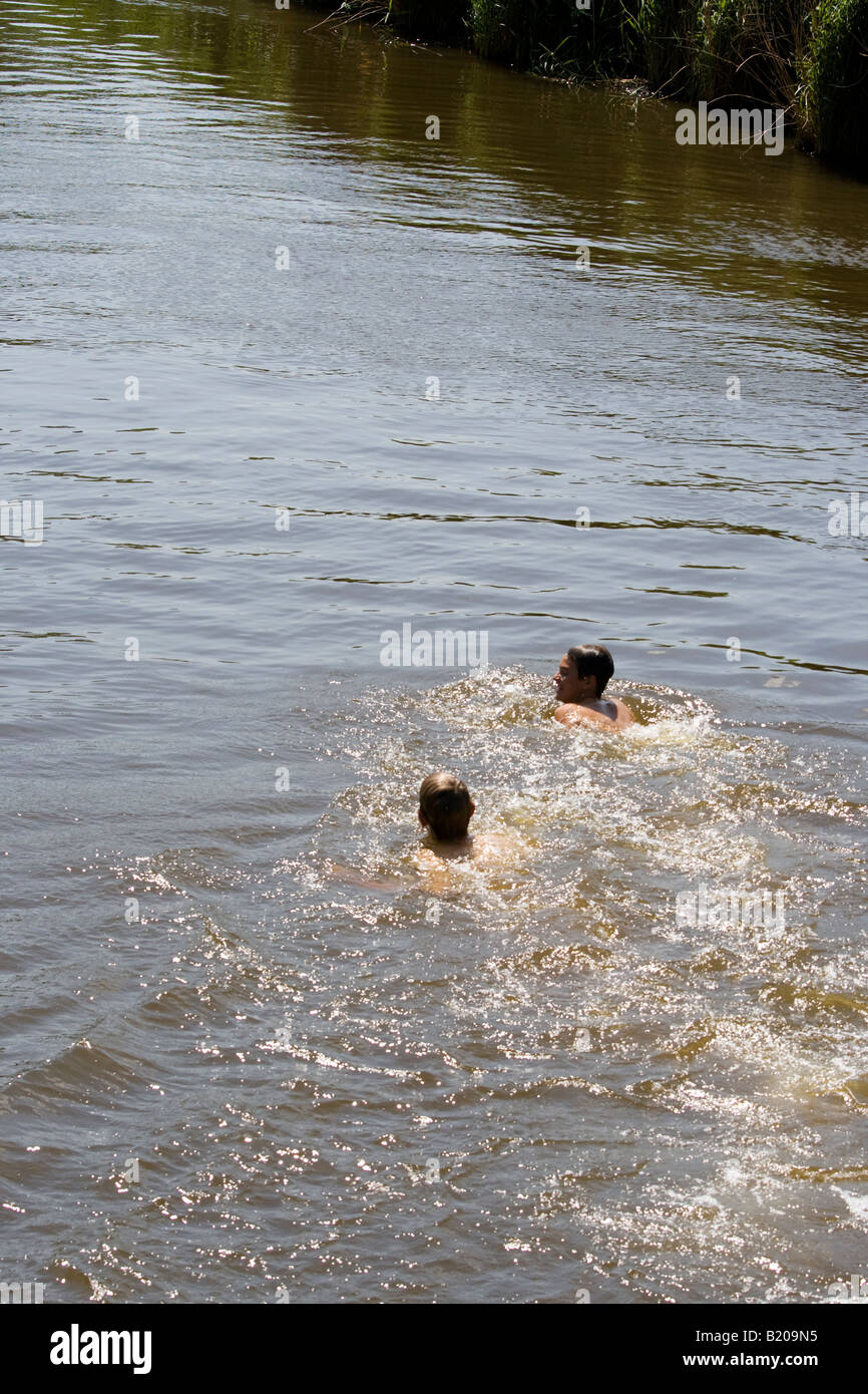 Boys swimming in river Stock Photo Alamy