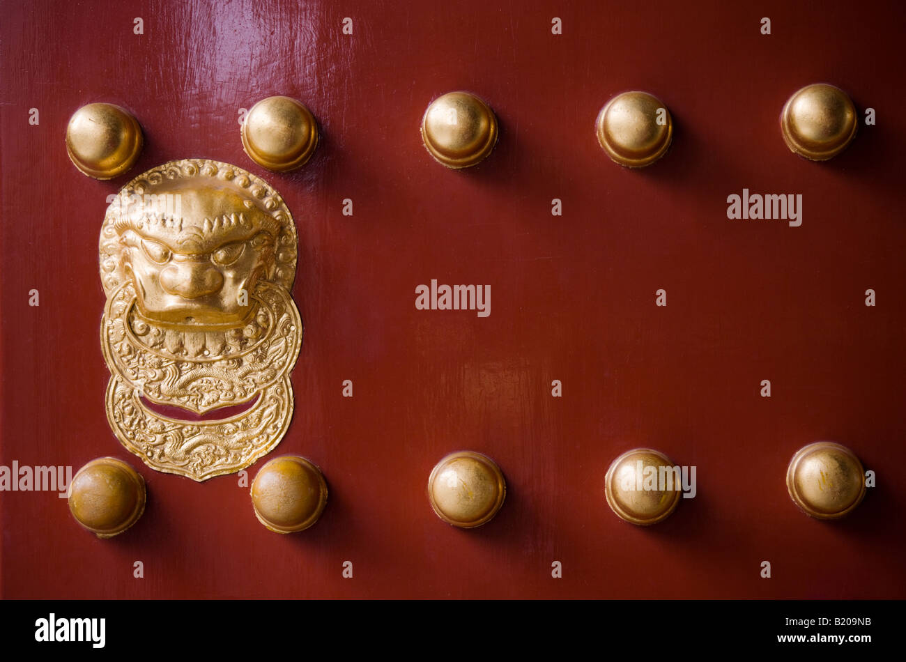 Nails and lion head knocker on gate to Tower of Buddhist Incense at The Summer Palace Beijing China Stock Photo