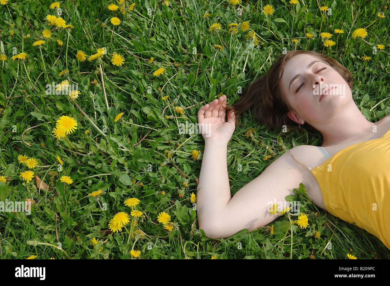 Young woman lying on a meadow Stock Photo Alamy