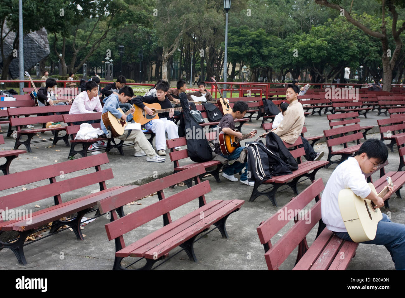 Young Taiwanese musicians gather to play guitars in a park, Taipei