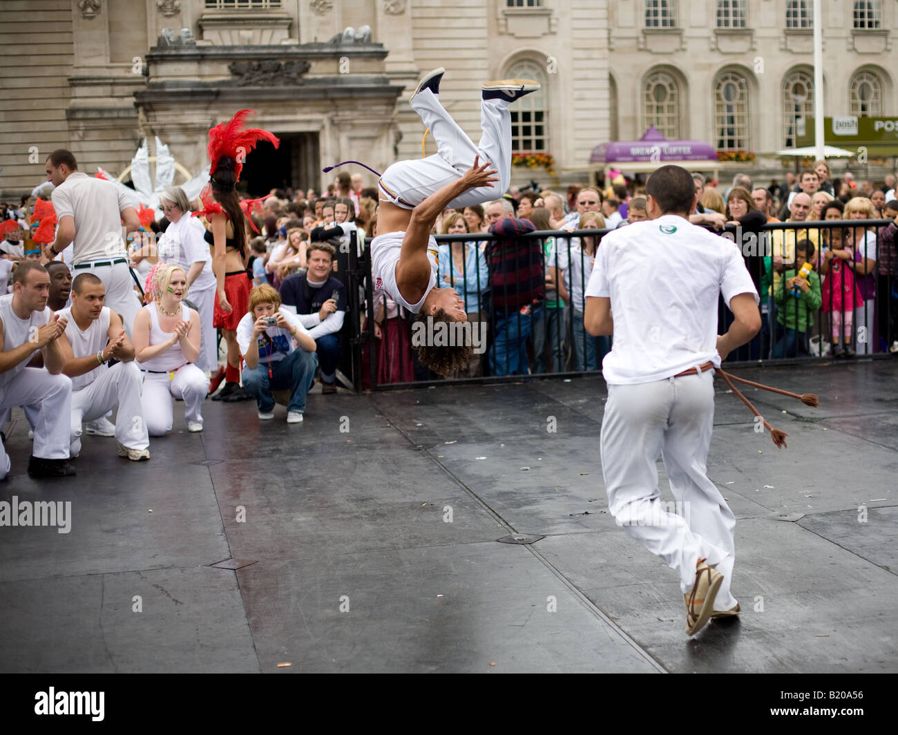 A man performs a somersault during the parade for the MAS/SWICA Carnival in Cardiff. Stock Photo