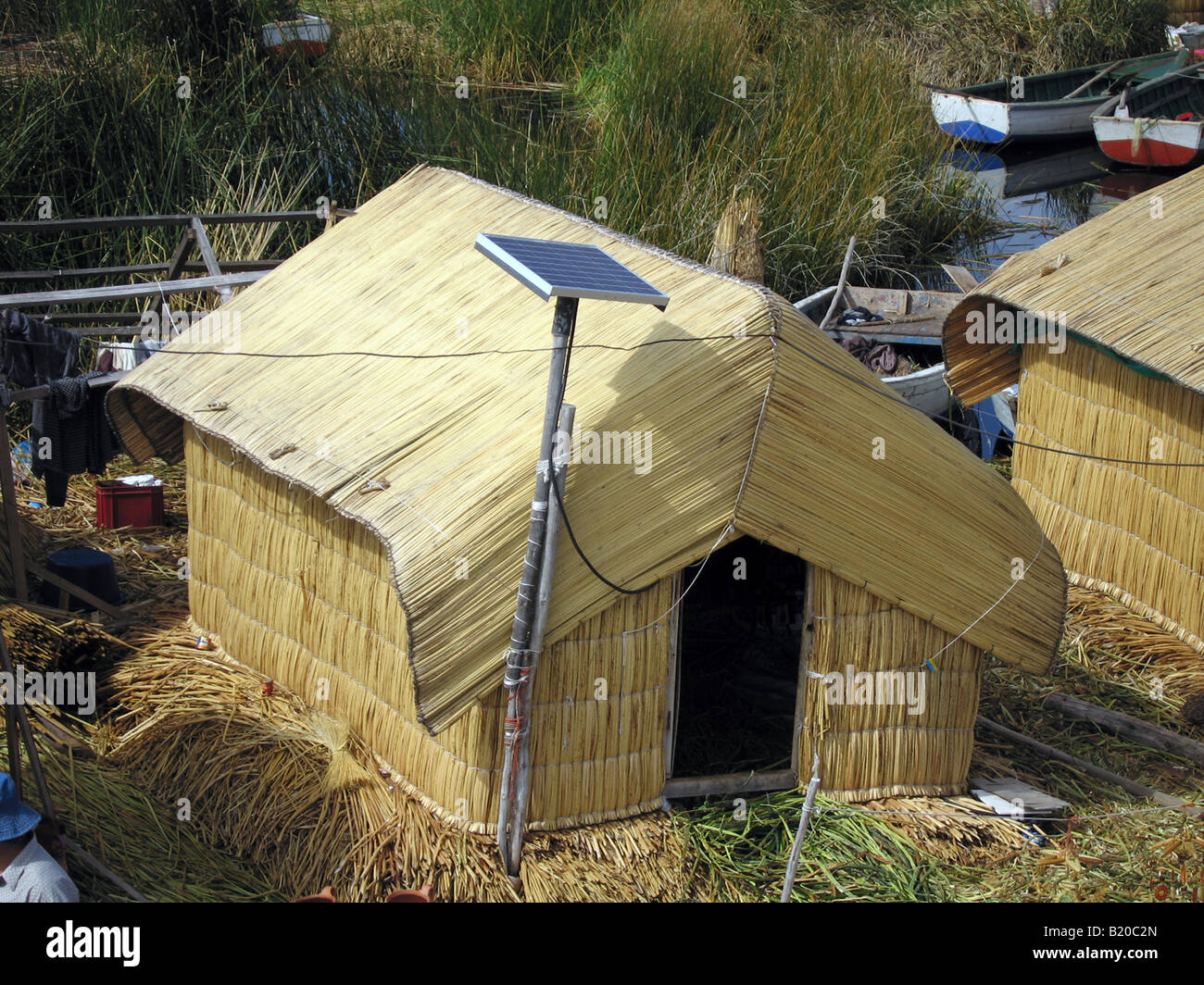 Solar energy panels attached to a reed house in the floating islands ...