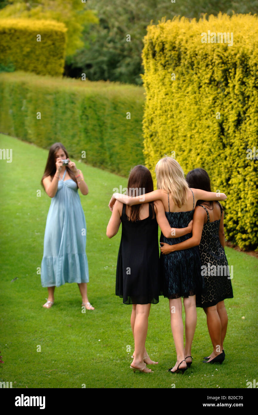 YOUNG WOMEN IN PARTY DRESSES AT A SUMMER GARDEN FUNCTION UK Stock Photo