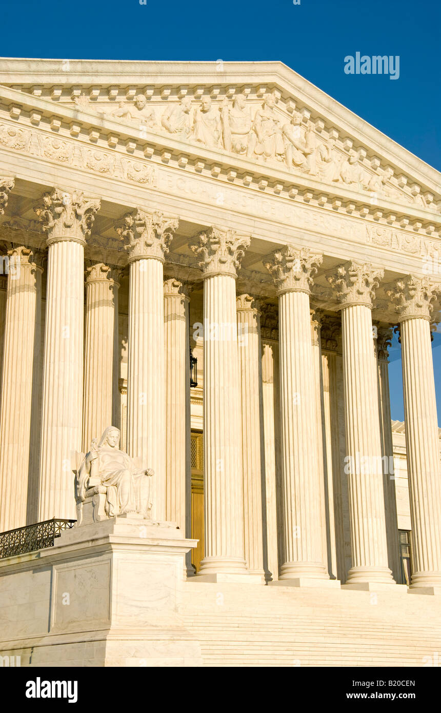United States Supreme Court Building Contemplation Of Justice Statue Washington DC // WASHINGTON, D.C. — The western facade of the United States Supreme Court Building features the iconic 'Contemplation of Justice' statue at the lower left, created by sculptor James Earle Fraser in 1935. Above rises the ornate pediment, designed by Robert Aitken, depicting 'Equal Justice Under Law' with allegorical figures representing Order, Authority, and Liberty. The neoclassical building, completed in 1935, serves as the permanent home of the nation's highest court after the justices previously met within  Stock Photo