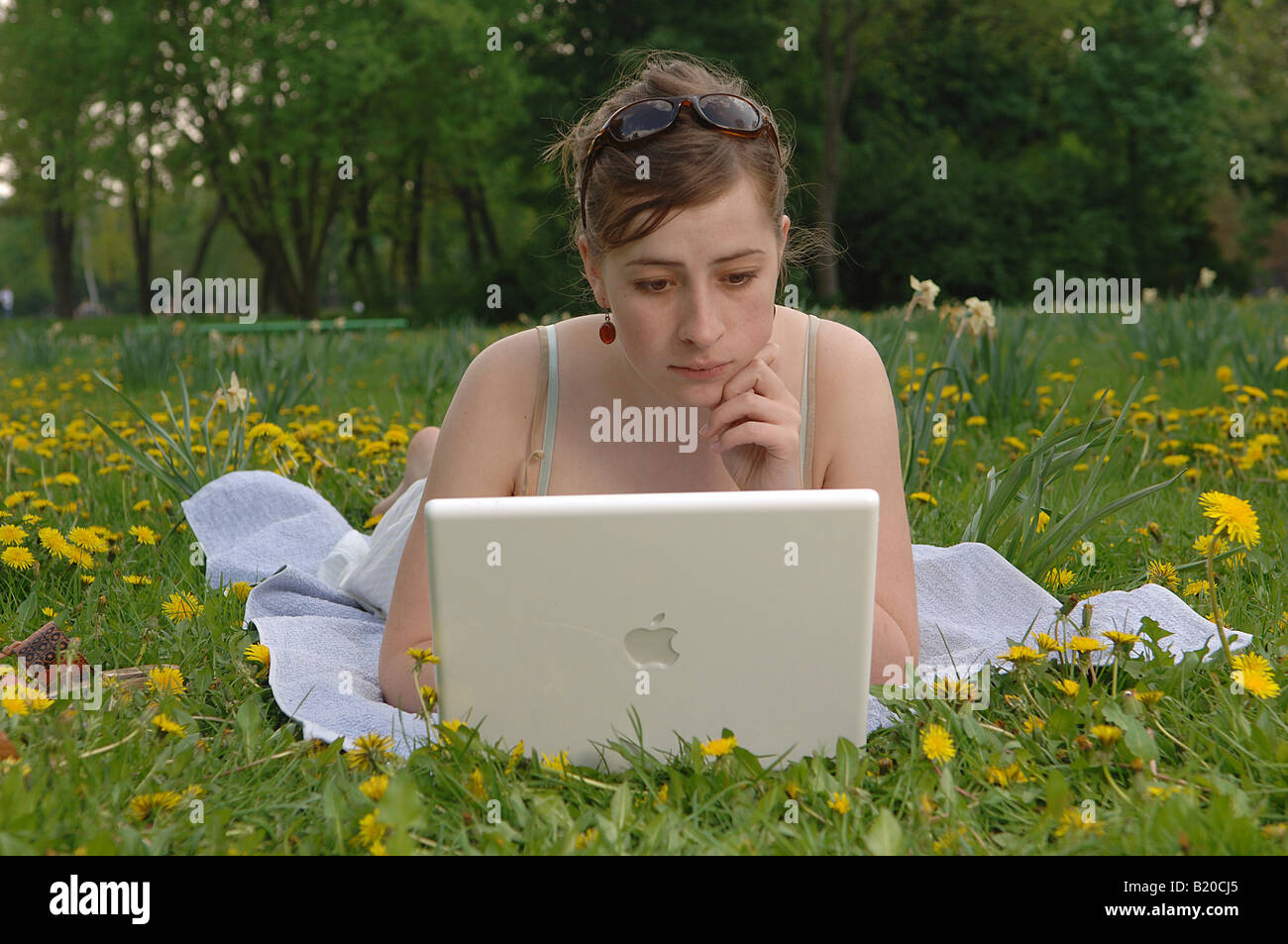 Young woman working on her laptop in a park Stock Photo
