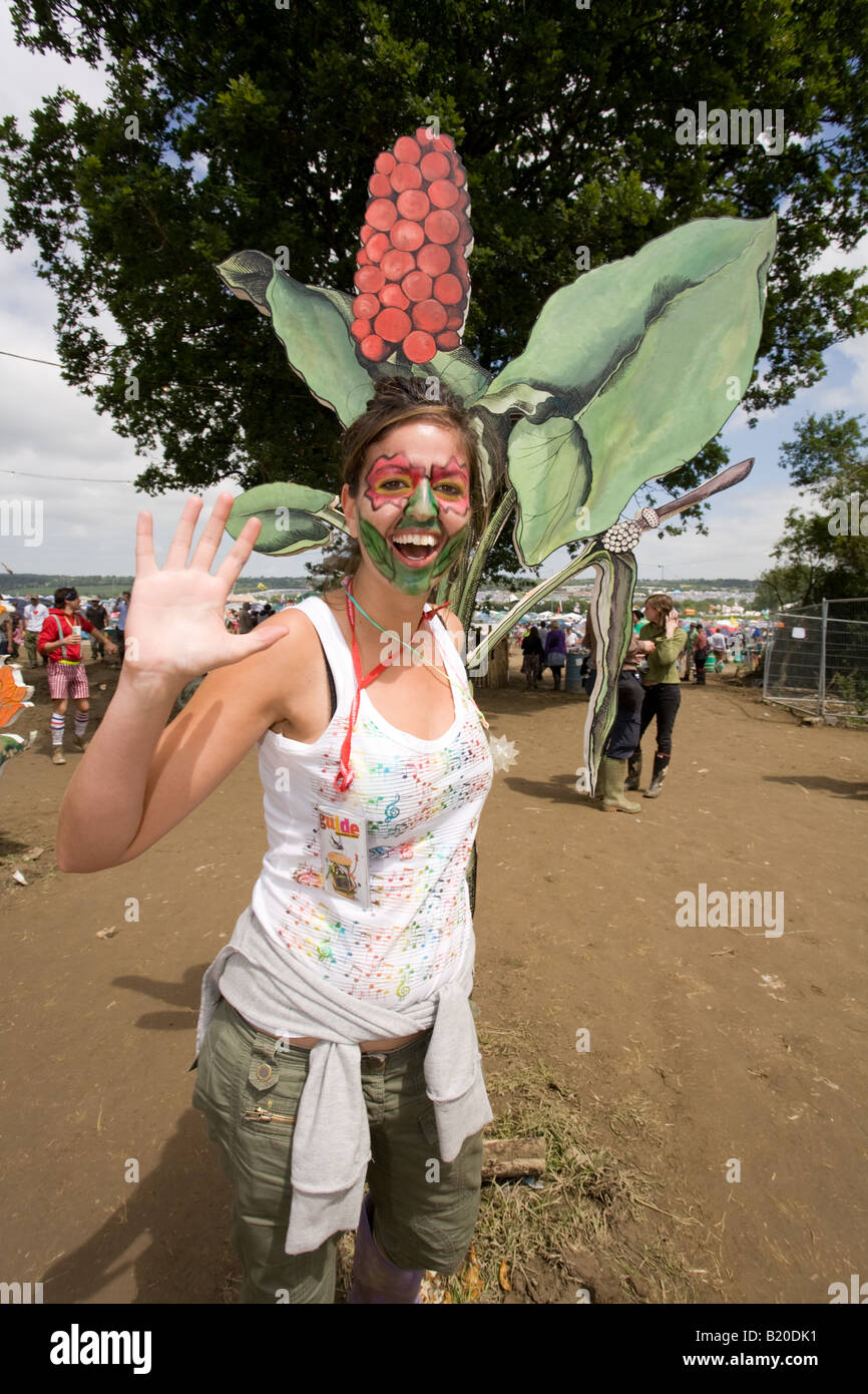 Woman next to a giant flower at the Glastonbury Festival 2008 Stock Photo