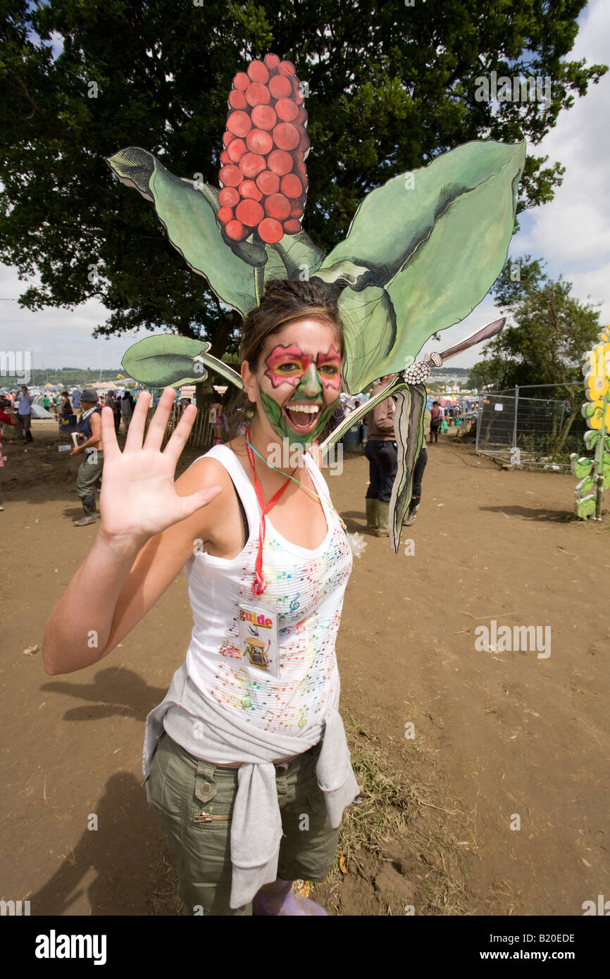 Woman next to a giant flower at the Glastonbury Festival 2008 Stock Photo