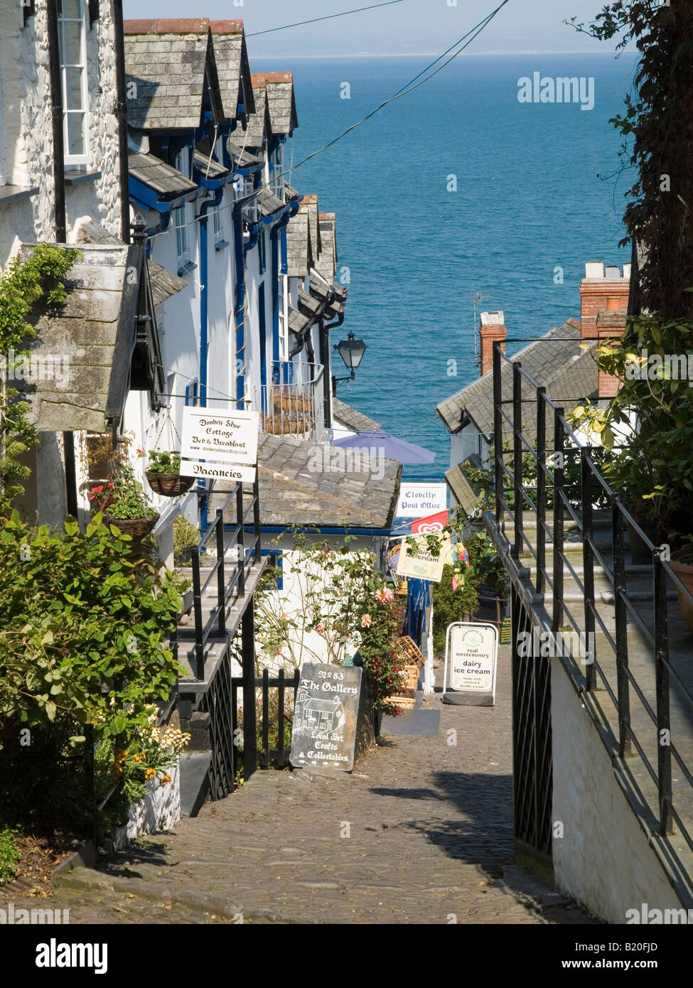 The steep cobbled street leading down to the harbour area in the historic fishing village of Clovelly, North Devon England UK Stock Photo