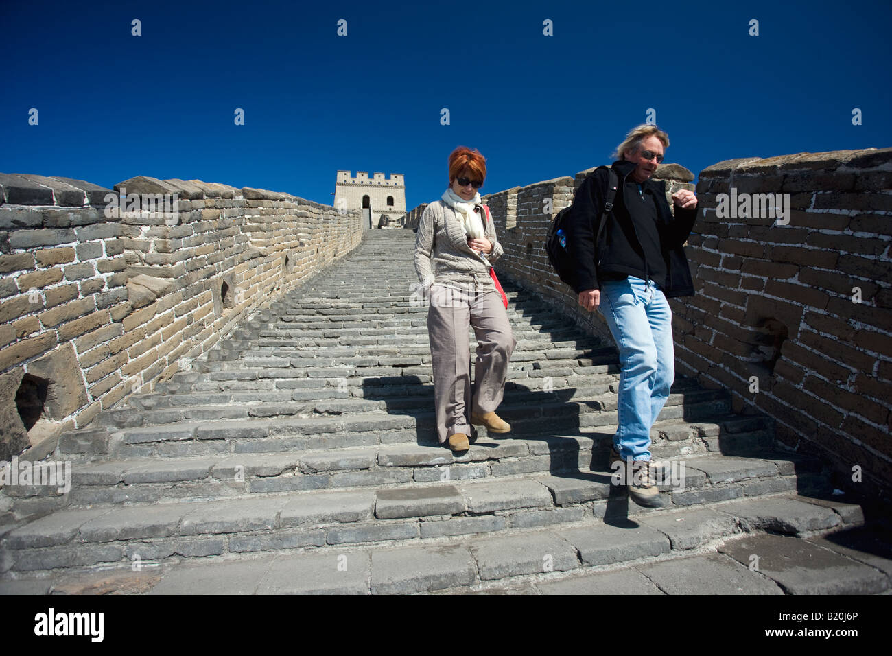 Western tourists walk the ancient Great Wall of China at Mutianyu north of Beijing China Stock Photo